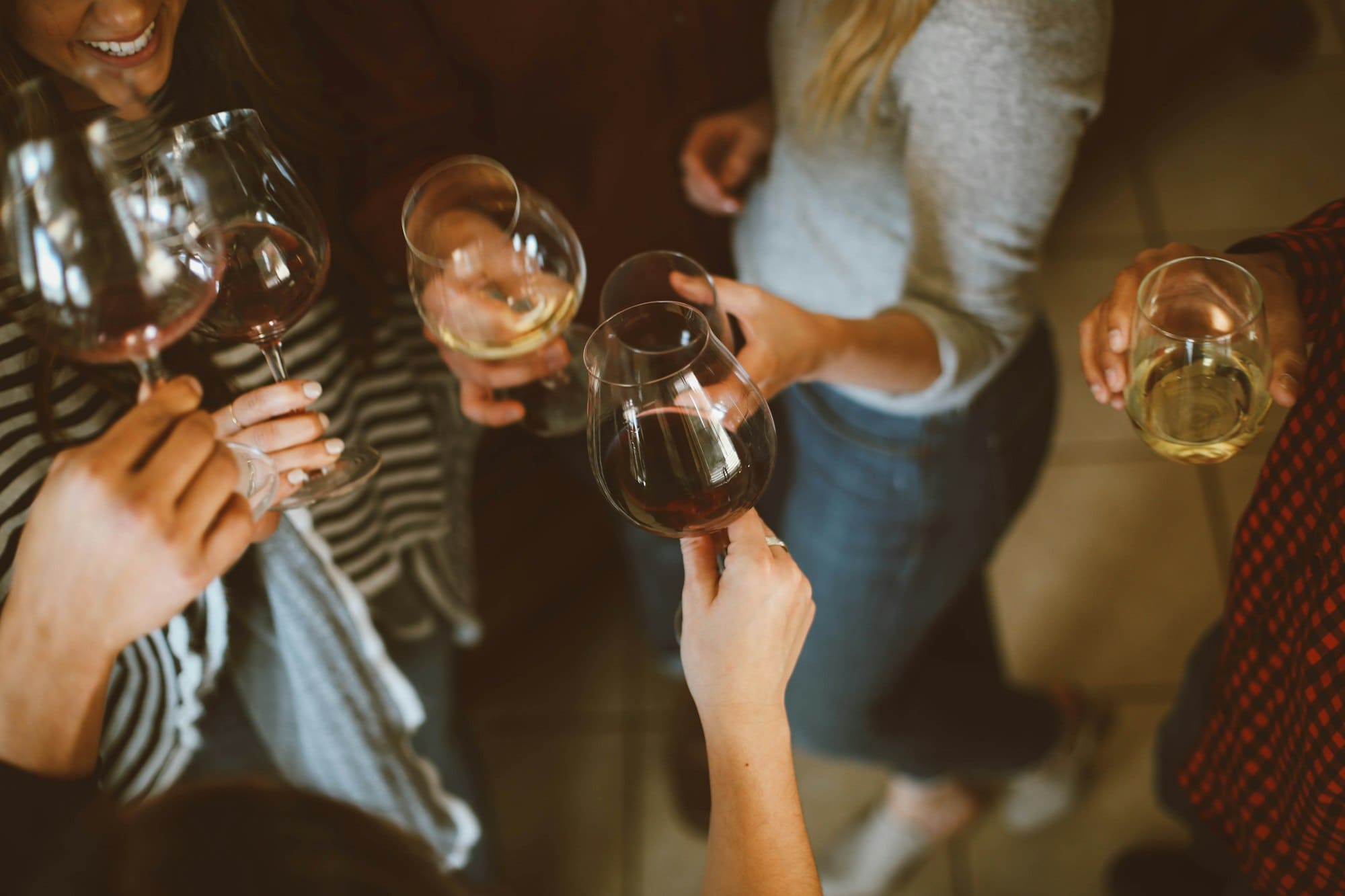 Guests raising glasses in a toast at an evening gathering