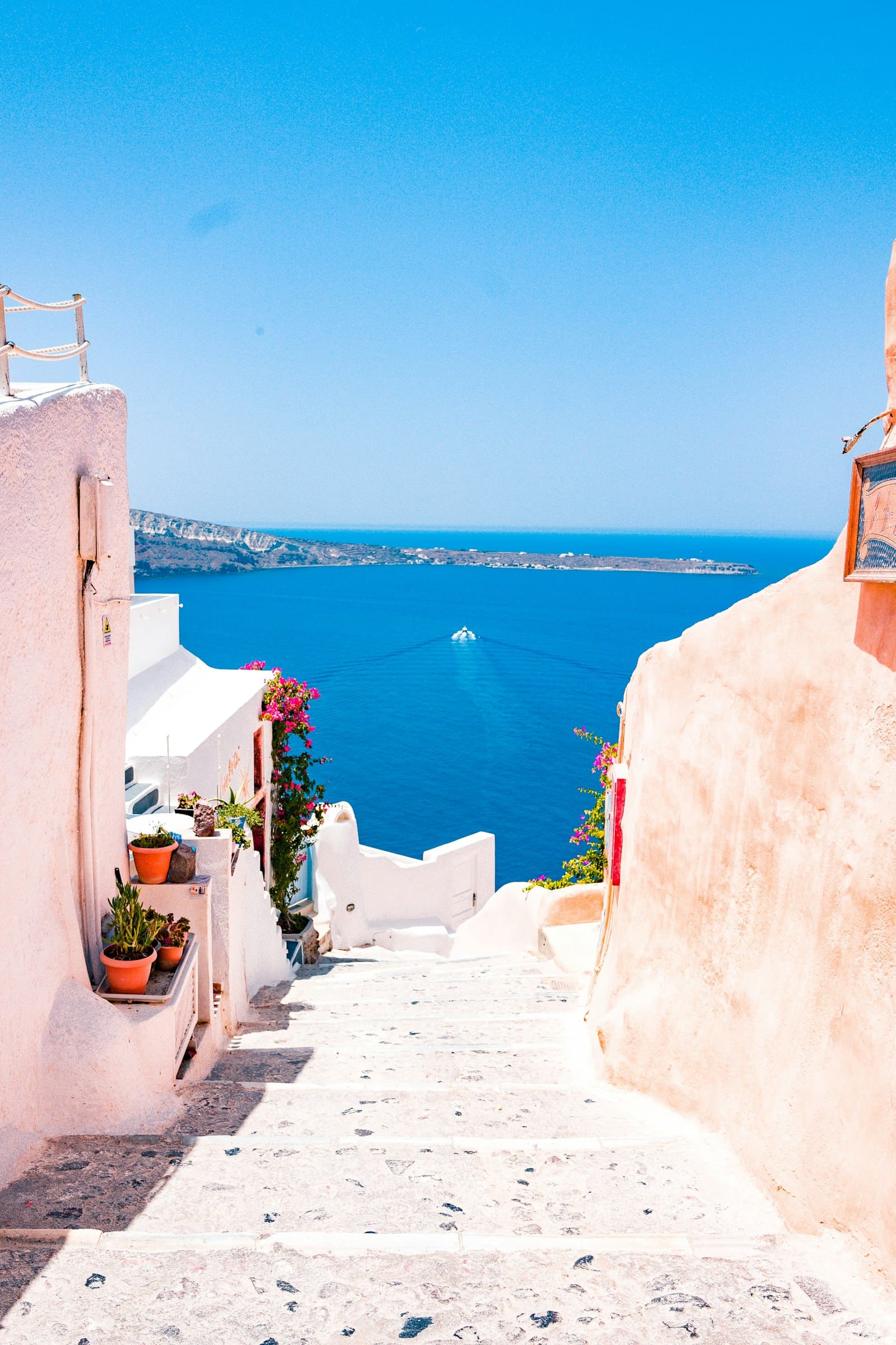 Whitewashed steps leading down towards a deep blue sea